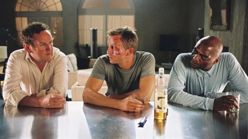 Colm Meaney as Gene, Daniel Craig as XXXX, and George Harris as Morty having a drink in Layer Cake (2004).