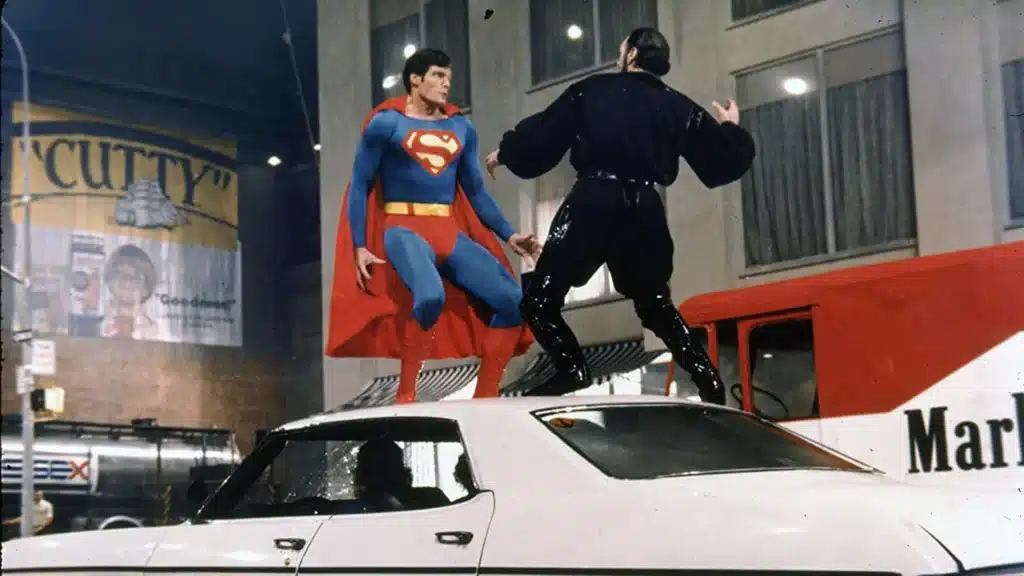 Christopher Reeve as Superman fighting Terence Stamp as General Zod on top of a car in Superman II (1980)