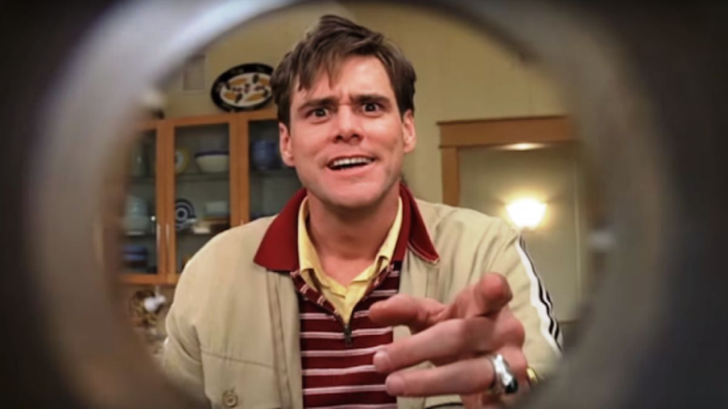 Jim Carrey looking through a peephole in The Truman Show (1998).
