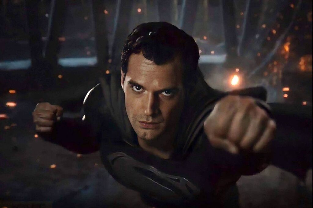 Henry Cavill as Superman in his black suit flying into battle in Zack Snyder’s Justice League (2021)