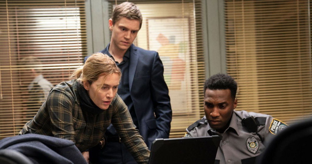 Kate Winslet, Evan Peters and Justin Hurtt-Dunkley in Mare of Easttown (2021).